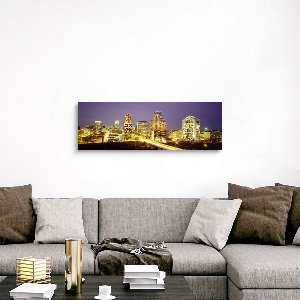 A traditional room featuring Panoramic photo of a cityscape brightly lit up at night with slow exposed car lights going throug...