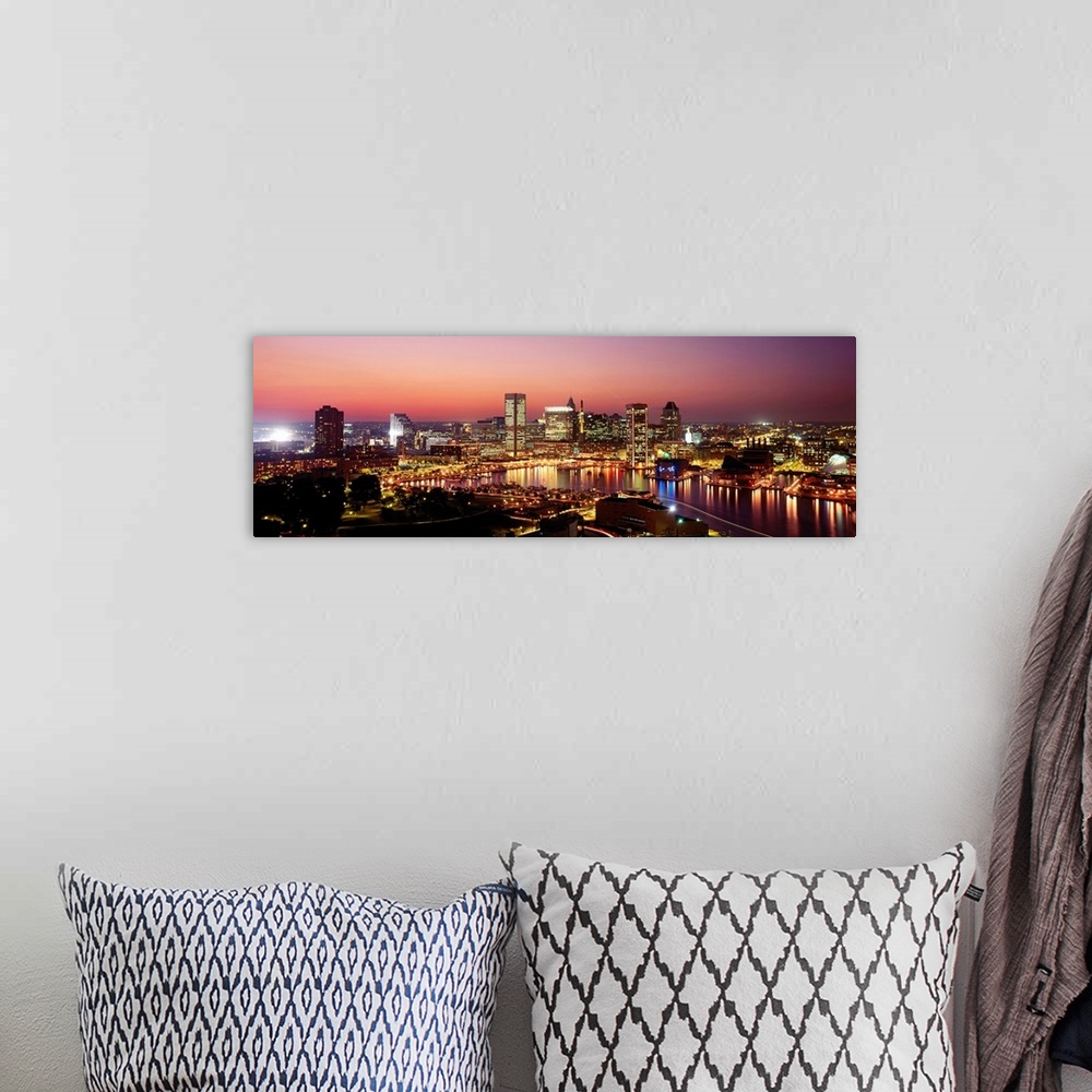 A bohemian room featuring High angle photograph of the Baltimore Inner harbor at night reflecting in the water.