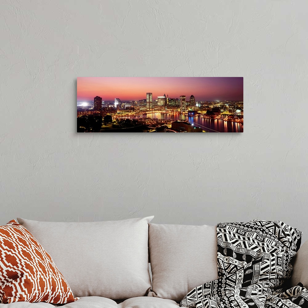 A bohemian room featuring High angle photograph of the Baltimore Inner harbor at night reflecting in the water.