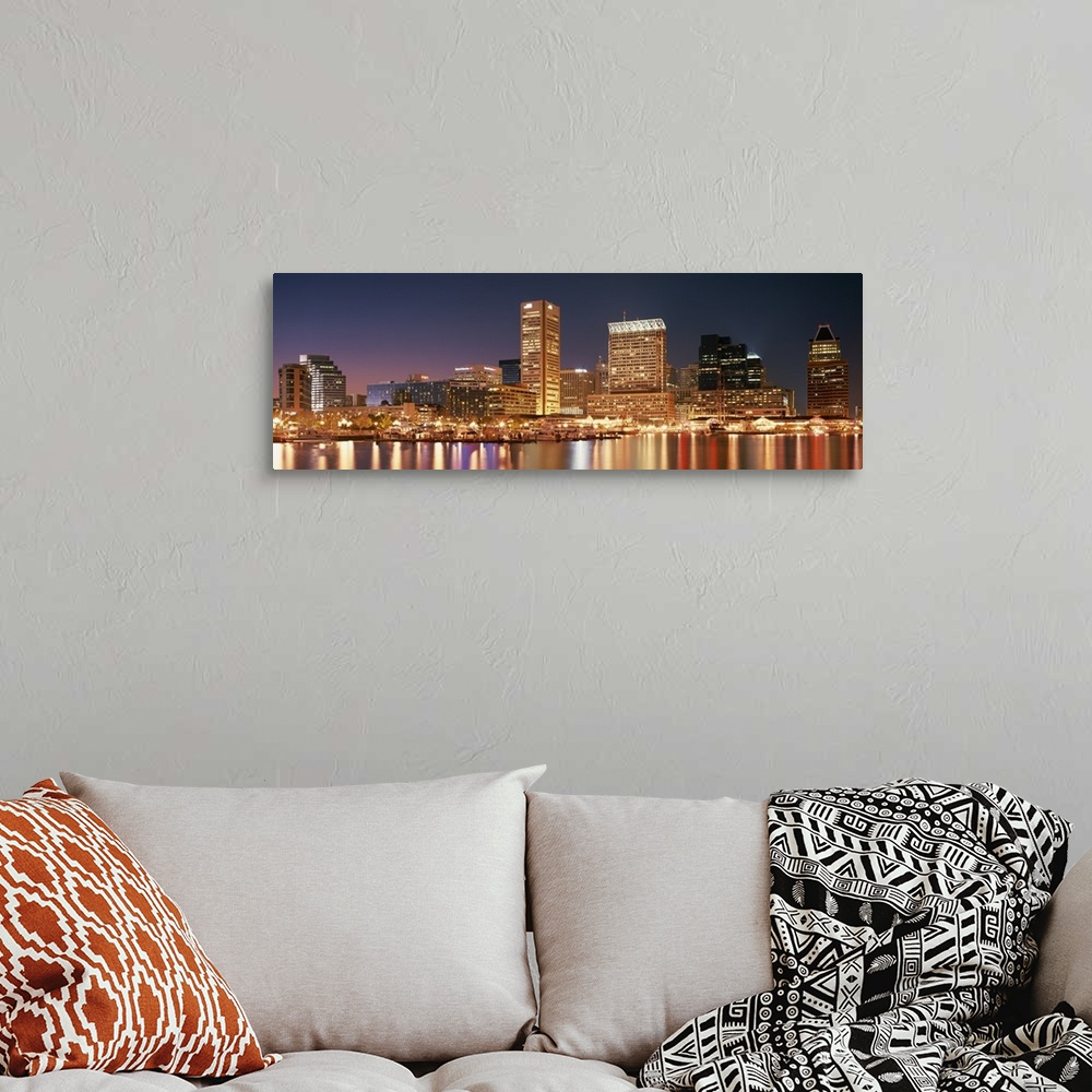 A bohemian room featuring Panoramic photograph of city skyline at night with lights from city glowing.  The city lights ref...