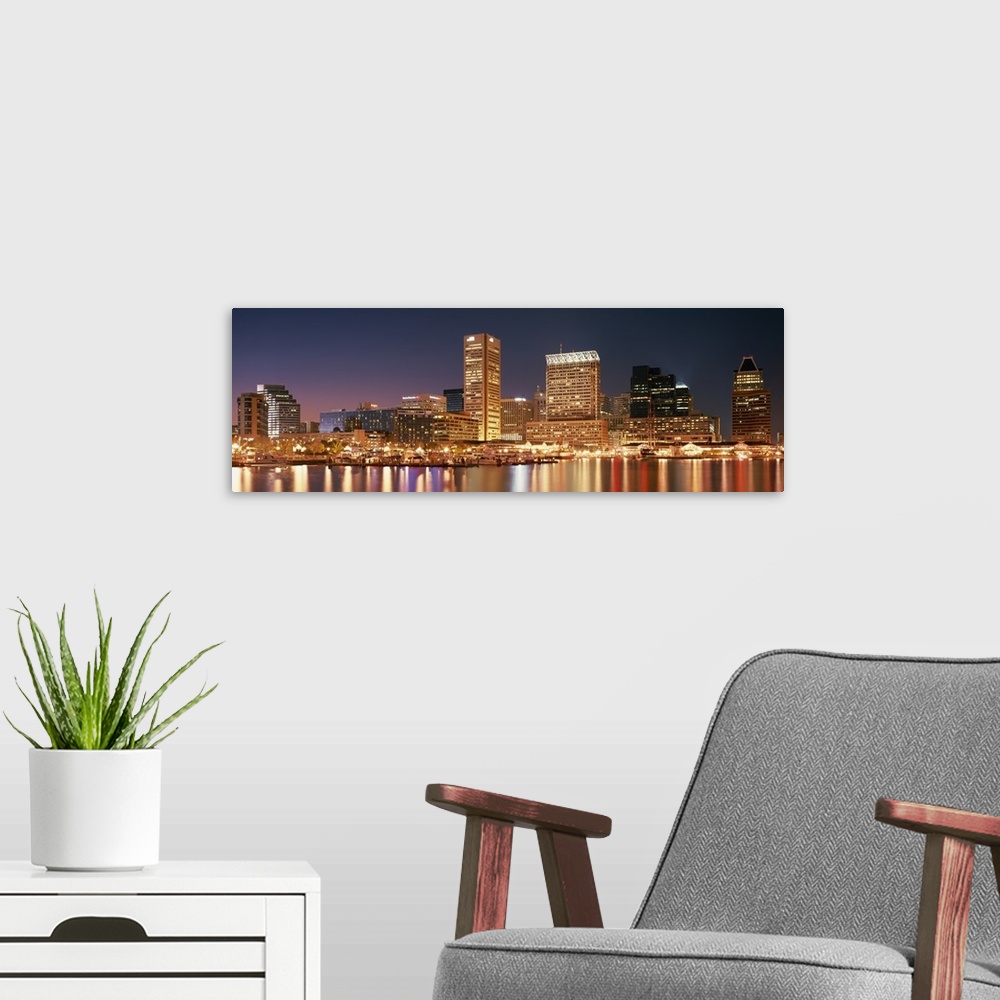 A modern room featuring Panoramic photograph of city skyline at night with lights from city glowing.  The city lights ref...