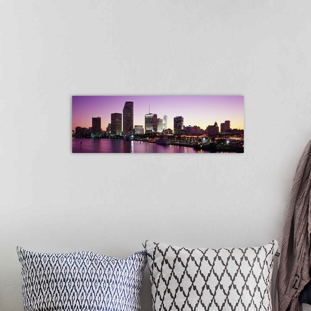 A bohemian room featuring Panoramic photo of the city skyline lighting up as the sun sets  in Miami, Florida.