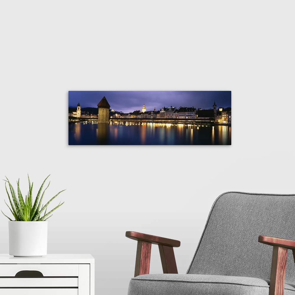A modern room featuring Buildings lit up at dusk, Chapel Bridge, Reuss River, Lucerne, Switzerland