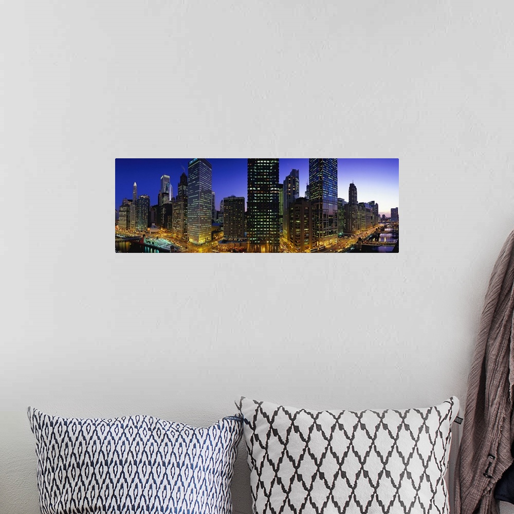 A bohemian room featuring Panoramic photograph of skyline with buildings and streets glowing in night sky.