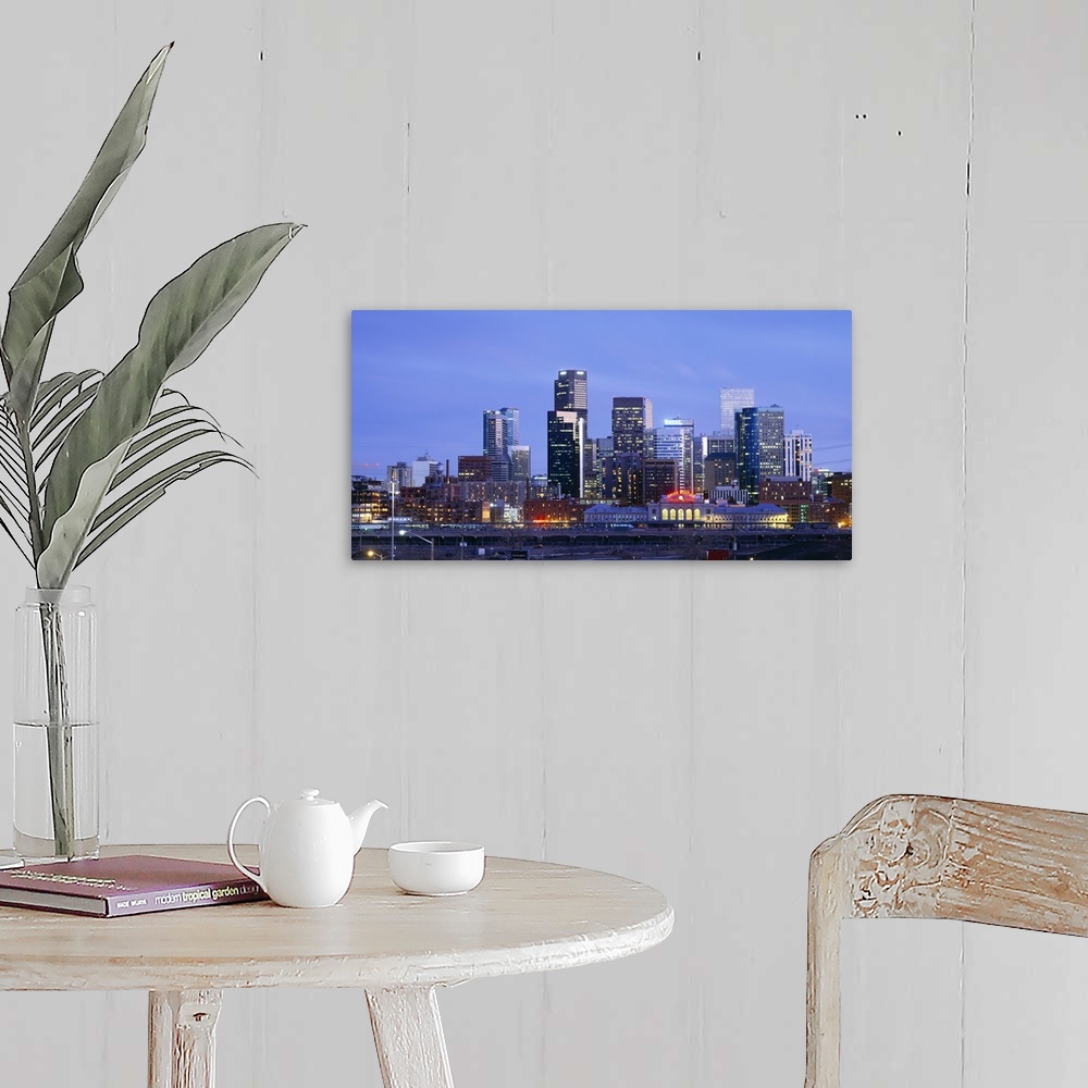A farmhouse room featuring A large panoramic piece of a photograph of the Denver skyline with the buildings lit up during su...