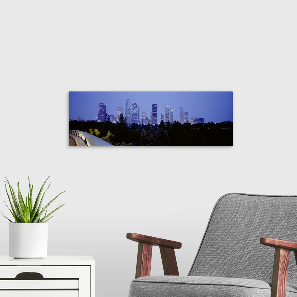 A modern room featuring Buildings lit up at dusk, Houston, Texas