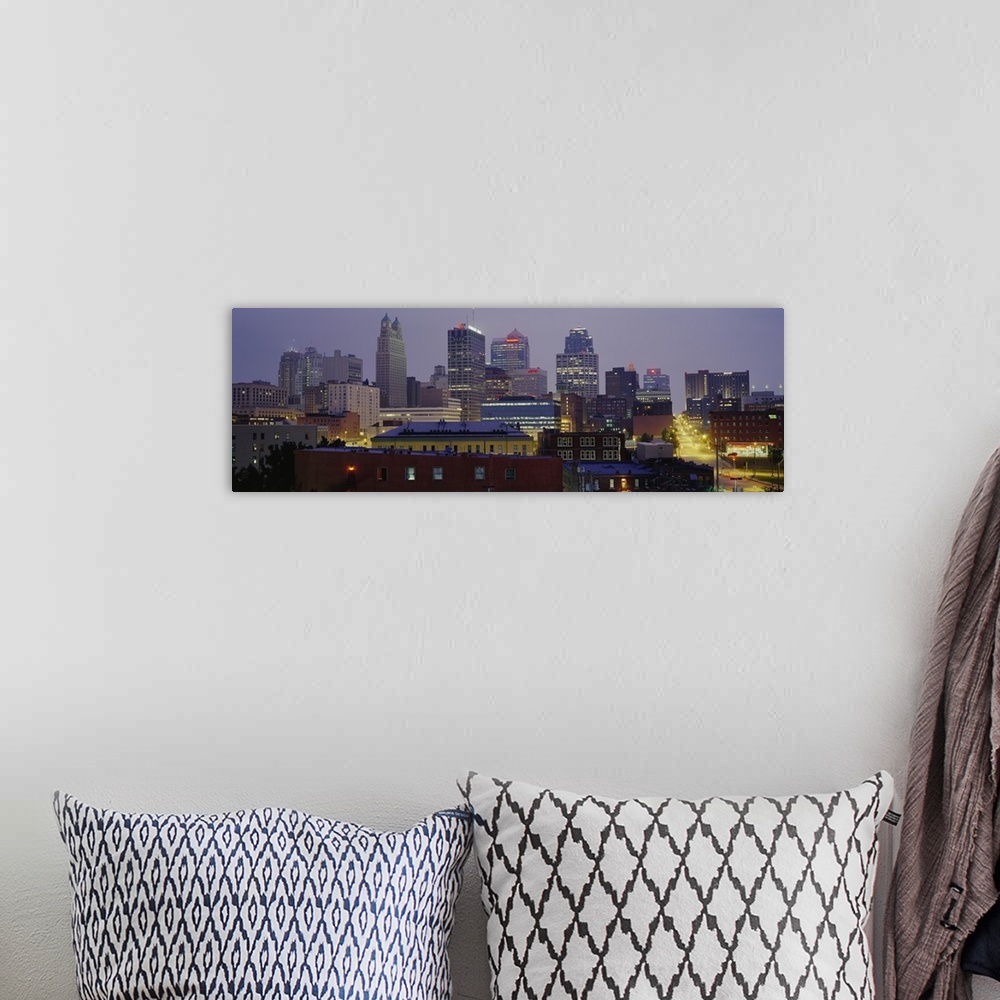 A bohemian room featuring A panoramic photograph of the downtown city skyline with several small residential or warehouse b...