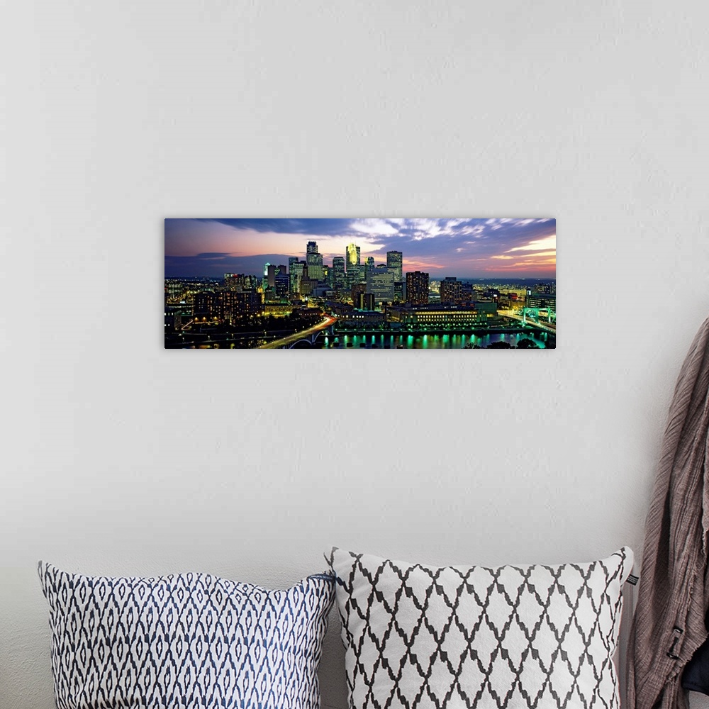 A bohemian room featuring Wide angle panoramic photograph of Minneapolis skyscrapers at night, beneath a colorful sunset.