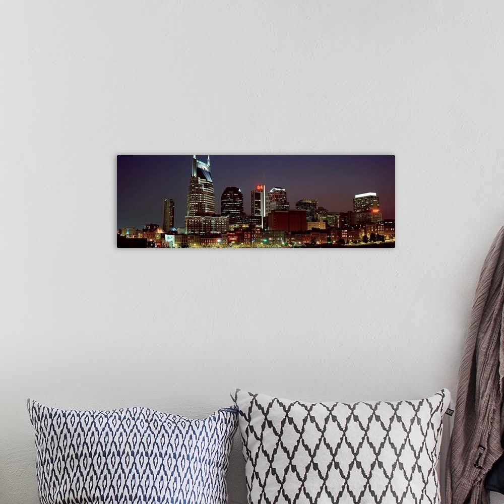 A bohemian room featuring Panoramic wall art for the home or office of high rise buildings in the Nashville skyline at night.