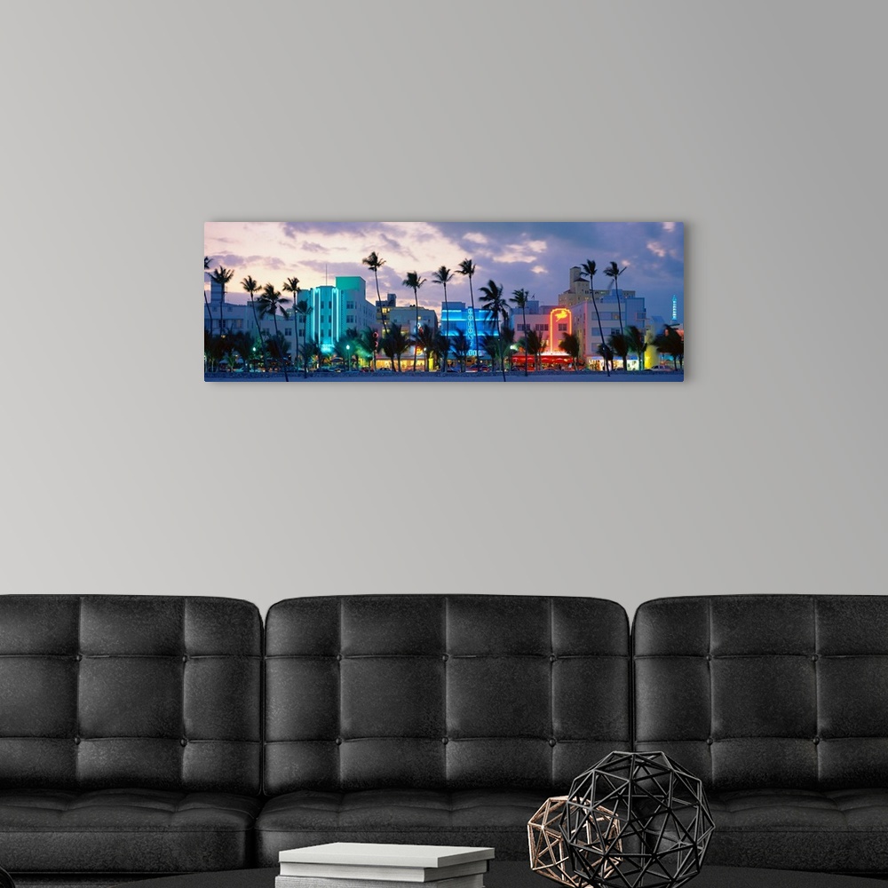 A modern room featuring Panoramic photograph includes a row of tall properties vibrantly shining alongside groups of palm...
