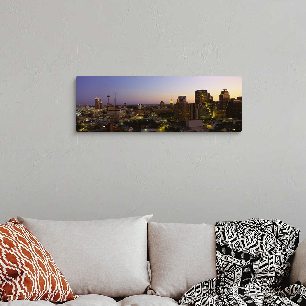 A bohemian room featuring Big panoramic view of the San Antonio skyline lit up while the sun is setting.