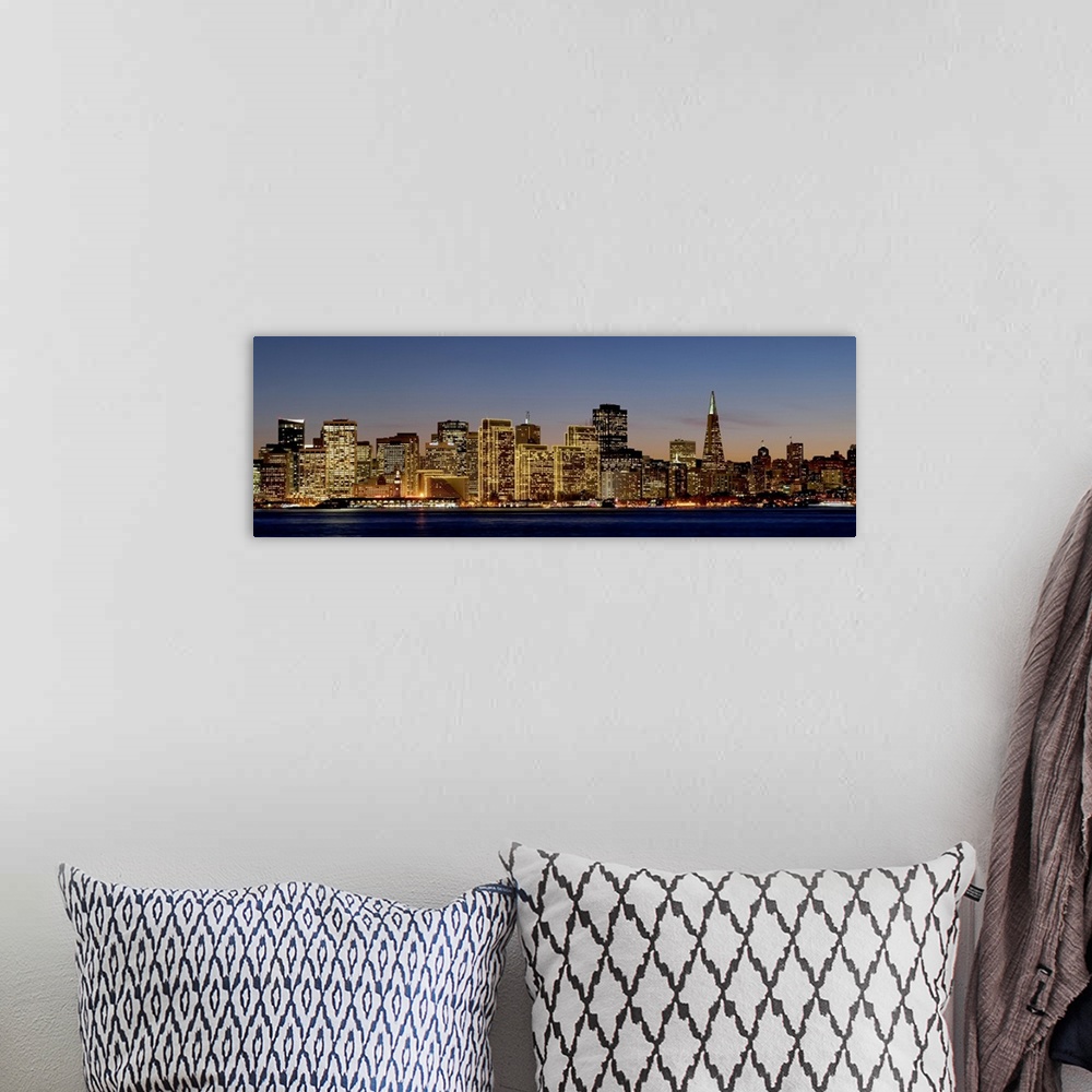 A bohemian room featuring Panoramic photograph of the San Francisco skyline with all of the buildings lit up under a sky at...
