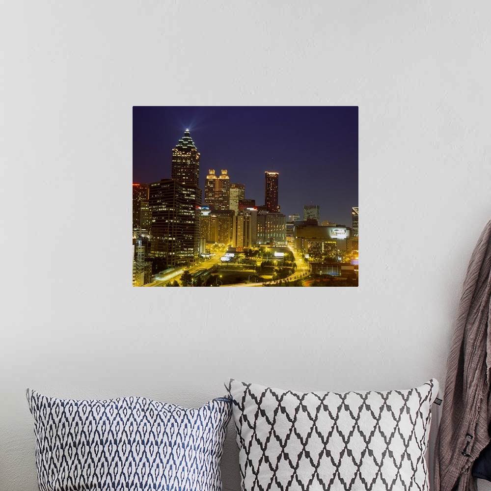A bohemian room featuring Large photograph displays a busy capital city in the Southeastern United States as the lights of ...