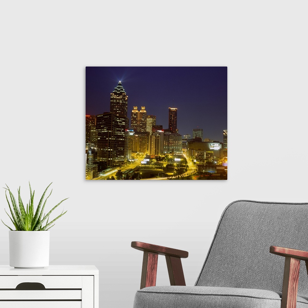 A modern room featuring Large photograph displays a busy capital city in the Southeastern United States as the lights of ...
