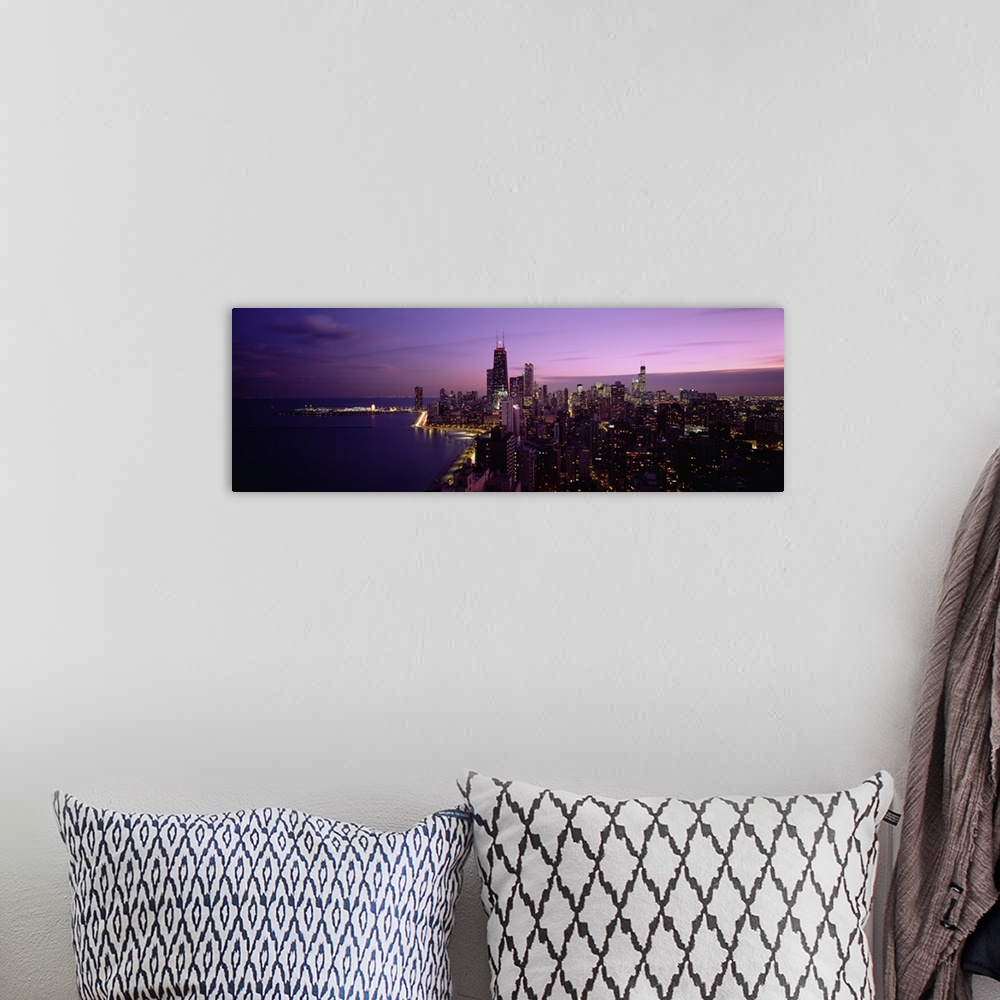 A bohemian room featuring Narrow and horizontal canvas of downtown Chicago lit up at night with the waterfront on the left.