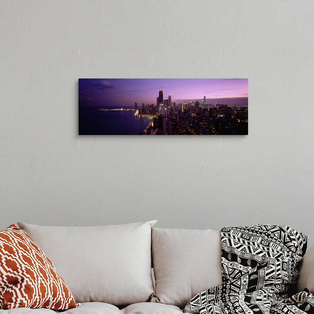 A bohemian room featuring Narrow and horizontal canvas of downtown Chicago lit up at night with the waterfront on the left.