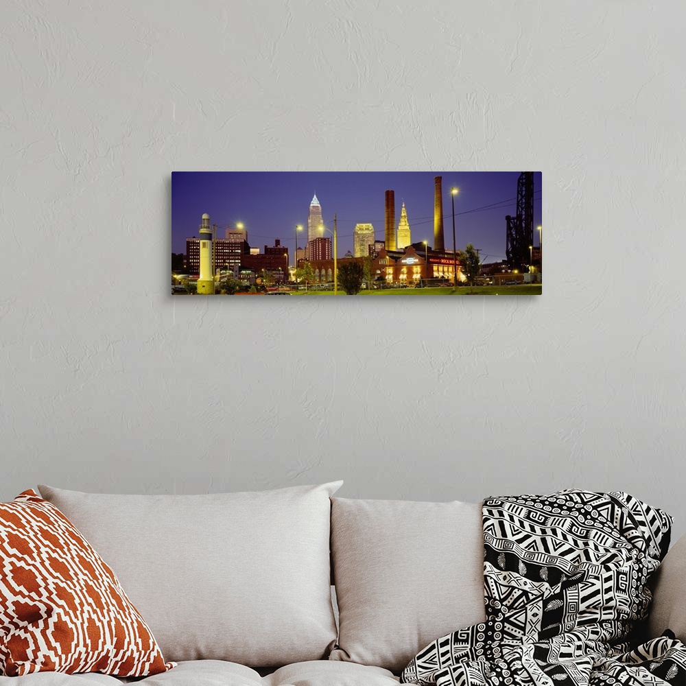 A bohemian room featuring Panoramic image of buildings lit up at night in a downtown Ohio city.