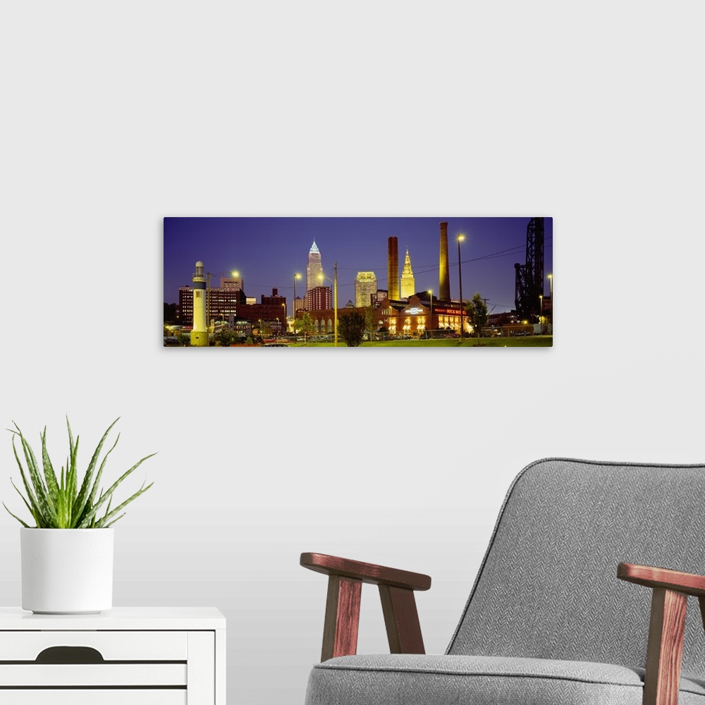 A modern room featuring Panoramic image of buildings lit up at night in a downtown Ohio city.
