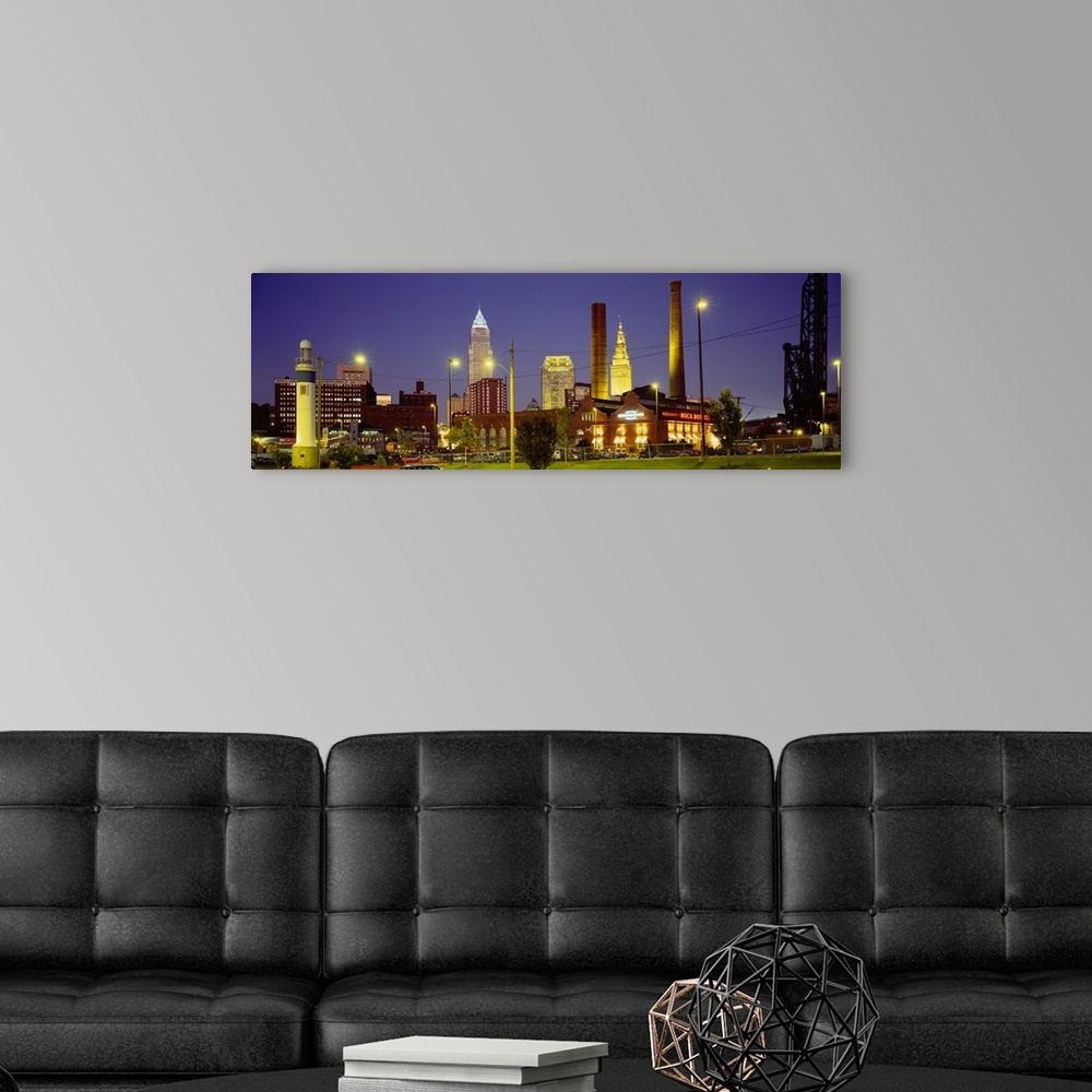 A modern room featuring Panoramic image of buildings lit up at night in a downtown Ohio city.
