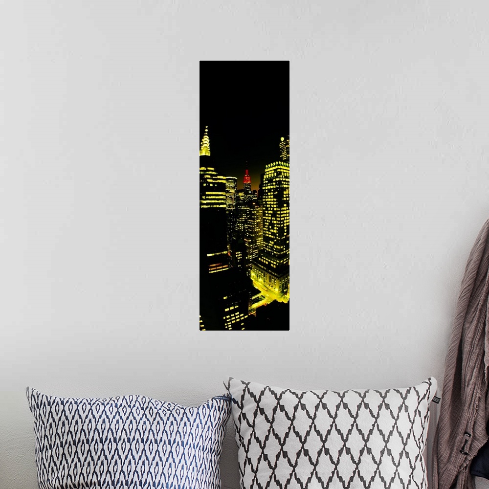 A bohemian room featuring Vertical panoramic of lit up office buildings in Manhattan with the Empire State building peeking...