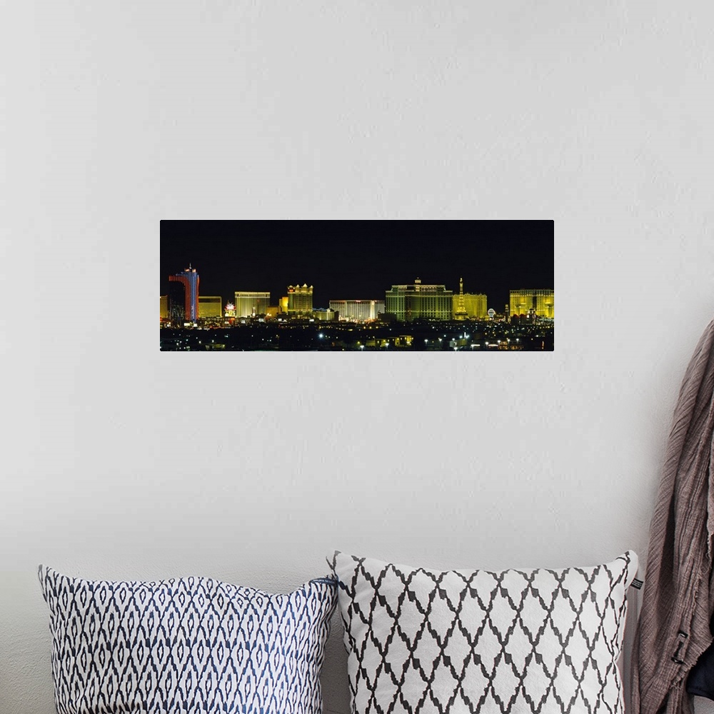 A bohemian room featuring Landscape photograph on an oversized wall hanging of the brightly lit buildings of the Las Vegas ...