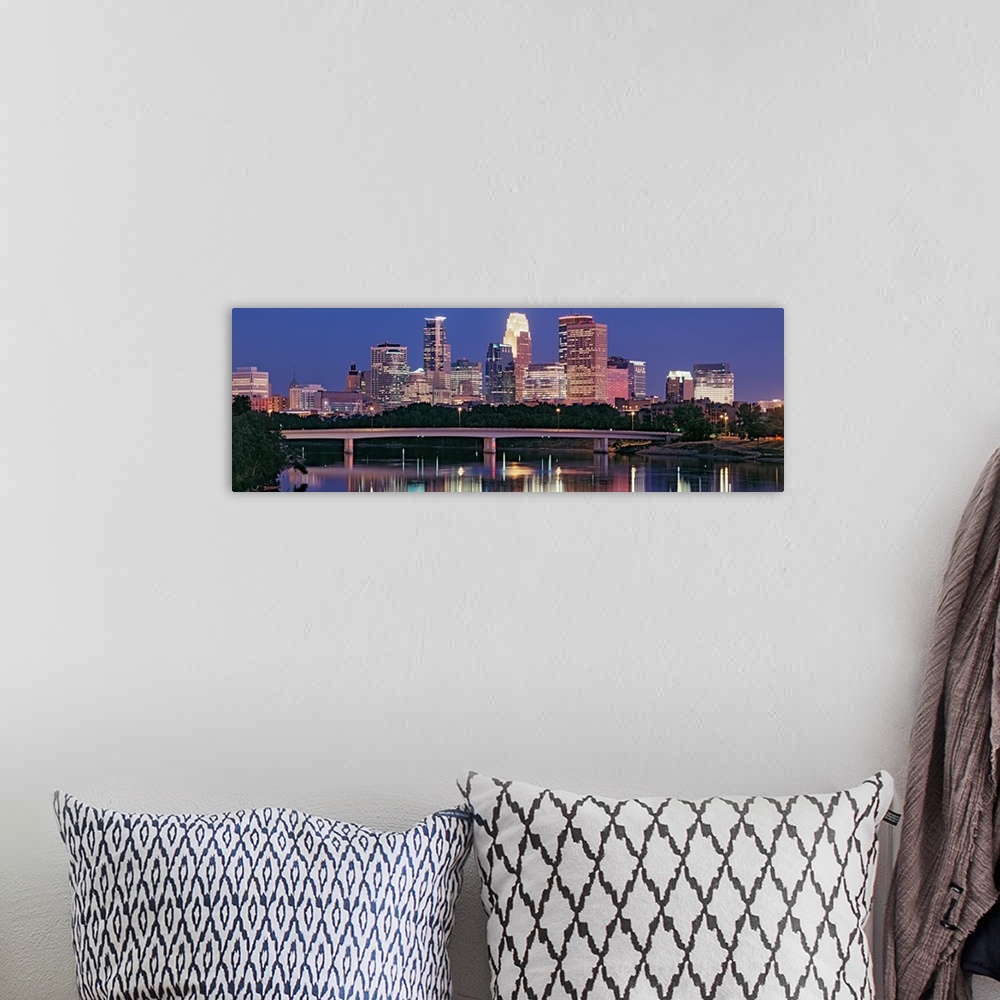 A bohemian room featuring Panoramic photograph includes a nighttime skyline for the largest city in Minnesota.  The gently ...