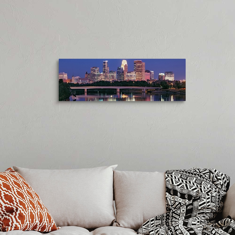A bohemian room featuring Panoramic photograph includes a nighttime skyline for the largest city in Minnesota.  The gently ...