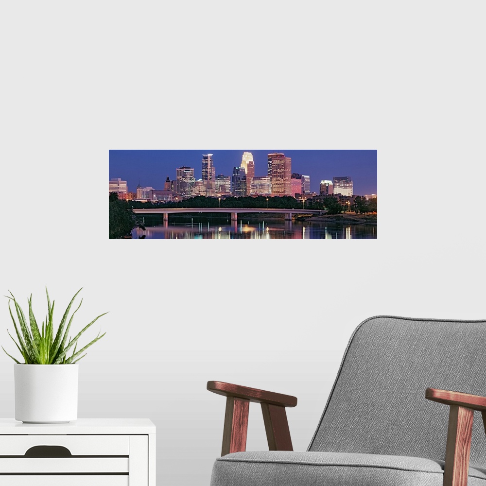 A modern room featuring Panoramic photograph includes a nighttime skyline for the largest city in Minnesota.  The gently ...