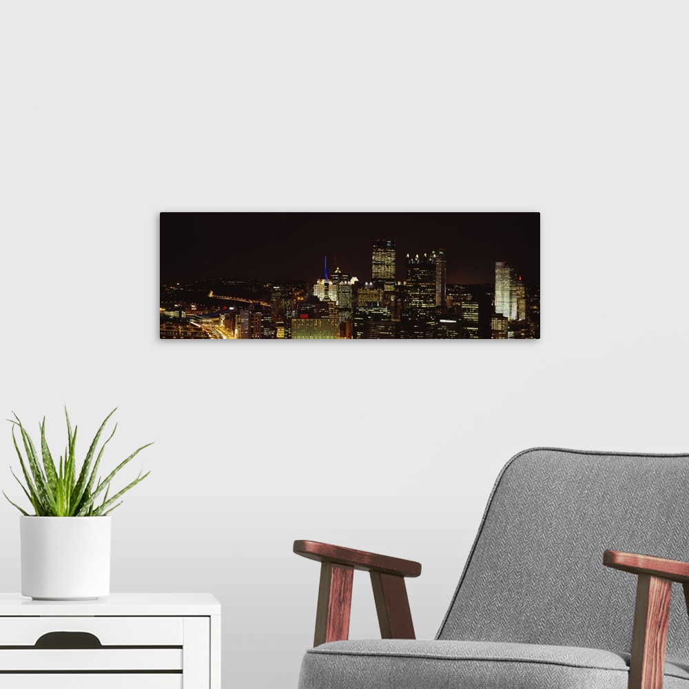 A modern room featuring Horizontal, big, high angle photograph of the Pittsburgh skyline, with brightly lit buildings at ...