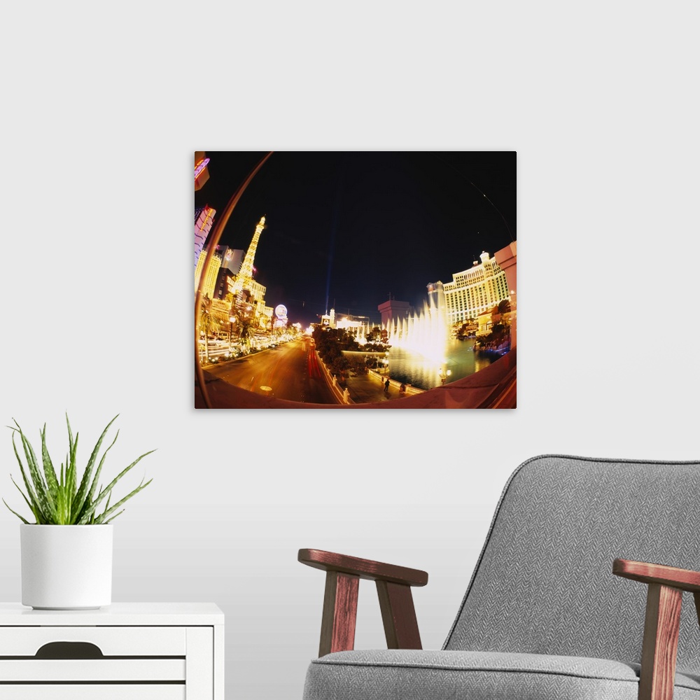 A modern room featuring Big photograph of downtown Las Vegas, Nevada (NV) lit up at night.