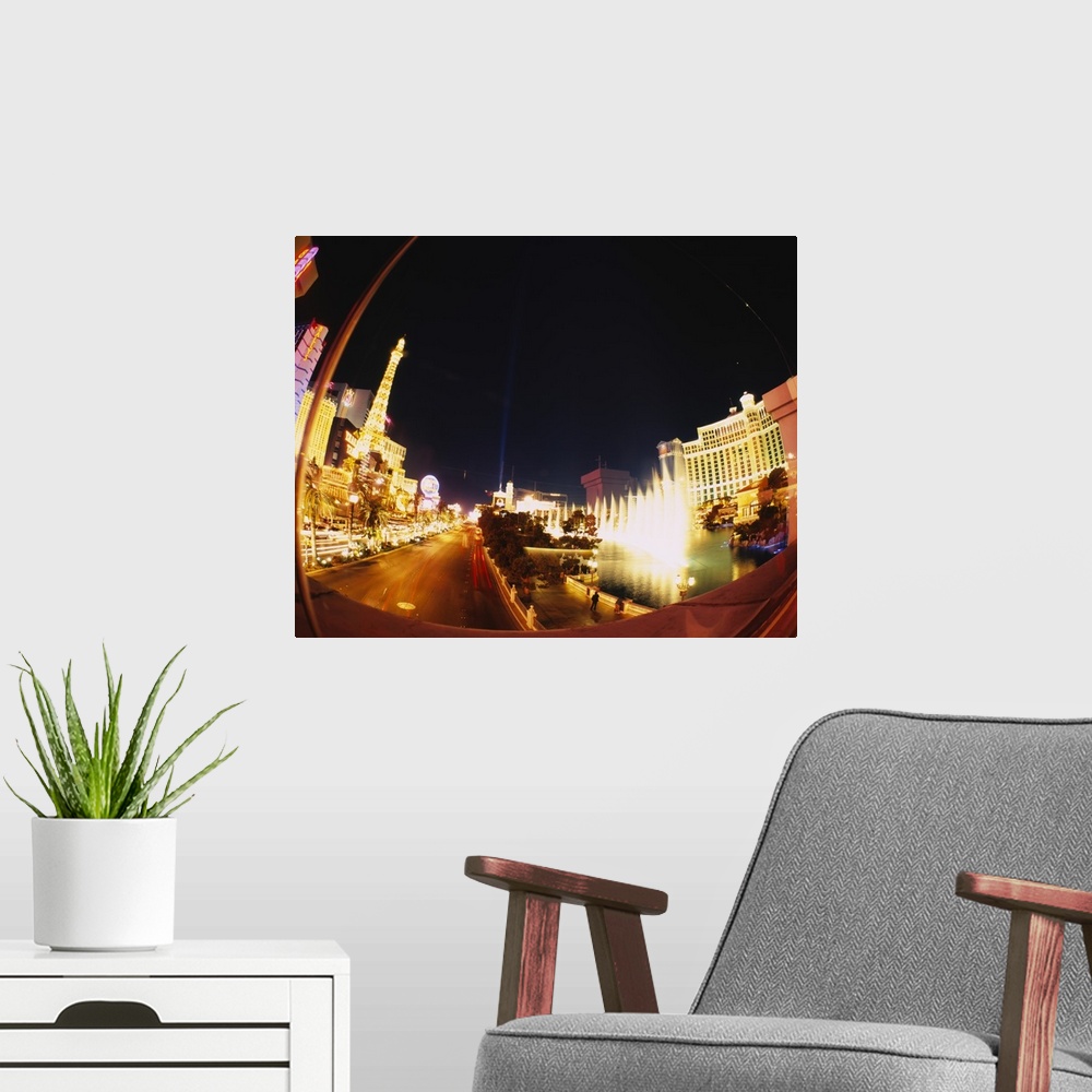 A modern room featuring Big photograph of downtown Las Vegas, Nevada (NV) lit up at night.