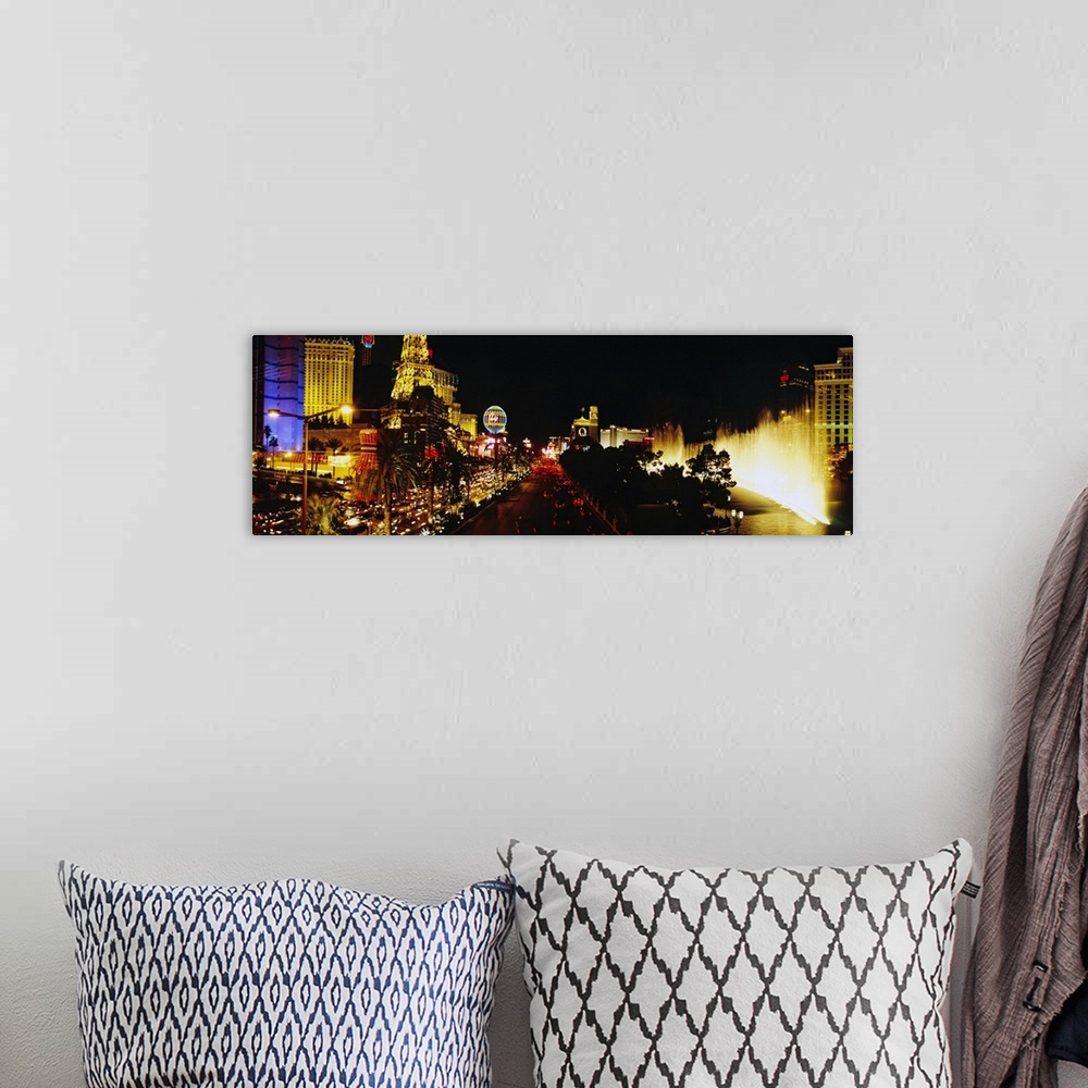 A bohemian room featuring Panoramic photograph displays the brightly lit strip of Las Vegas, Nevada filled with hotels, cas...