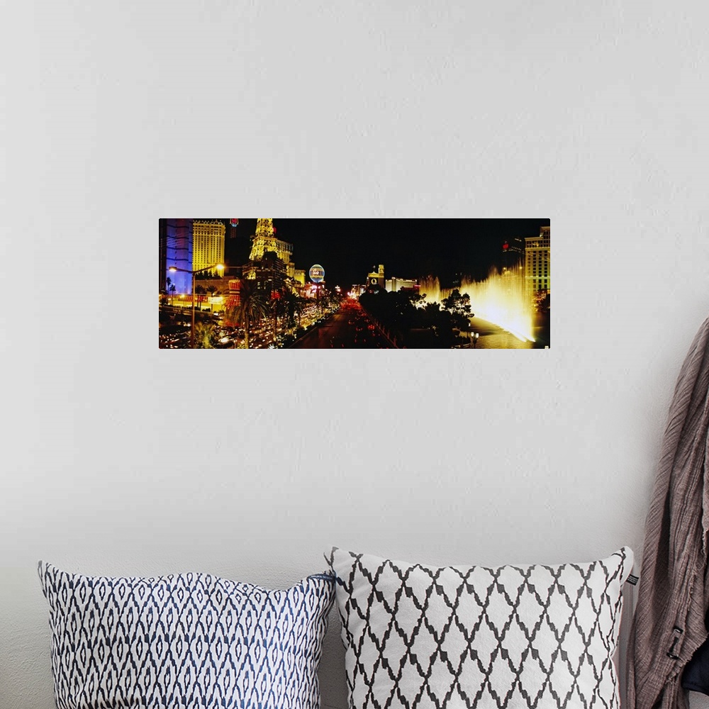 A bohemian room featuring Panoramic photograph displays the brightly lit strip of Las Vegas, Nevada filled with hotels, cas...