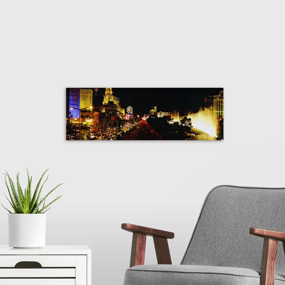 A modern room featuring Panoramic photograph displays the brightly lit strip of Las Vegas, Nevada filled with hotels, cas...