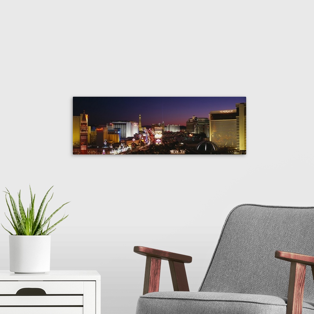 A modern room featuring Panoramic photograph focuses on the busy strip surrounded by famous hotels and casinos like The M...