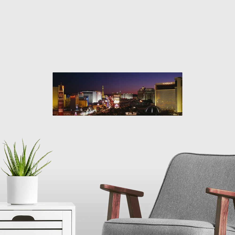 A modern room featuring Panoramic photograph focuses on the busy strip surrounded by famous hotels and casinos like The M...
