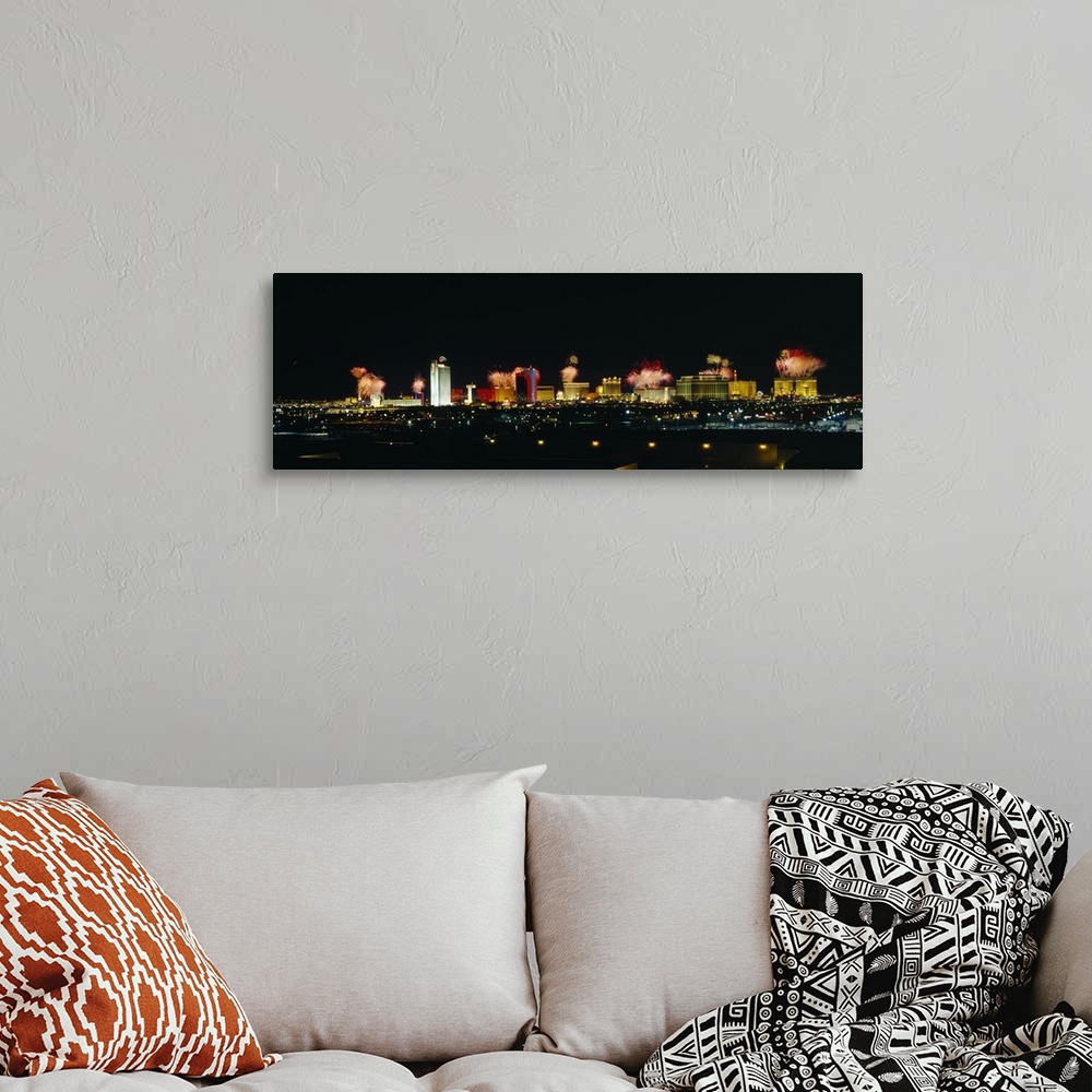 A bohemian room featuring A wide angle photograph taken of the Las Vegas strip at night with the buildings lit up and firew...