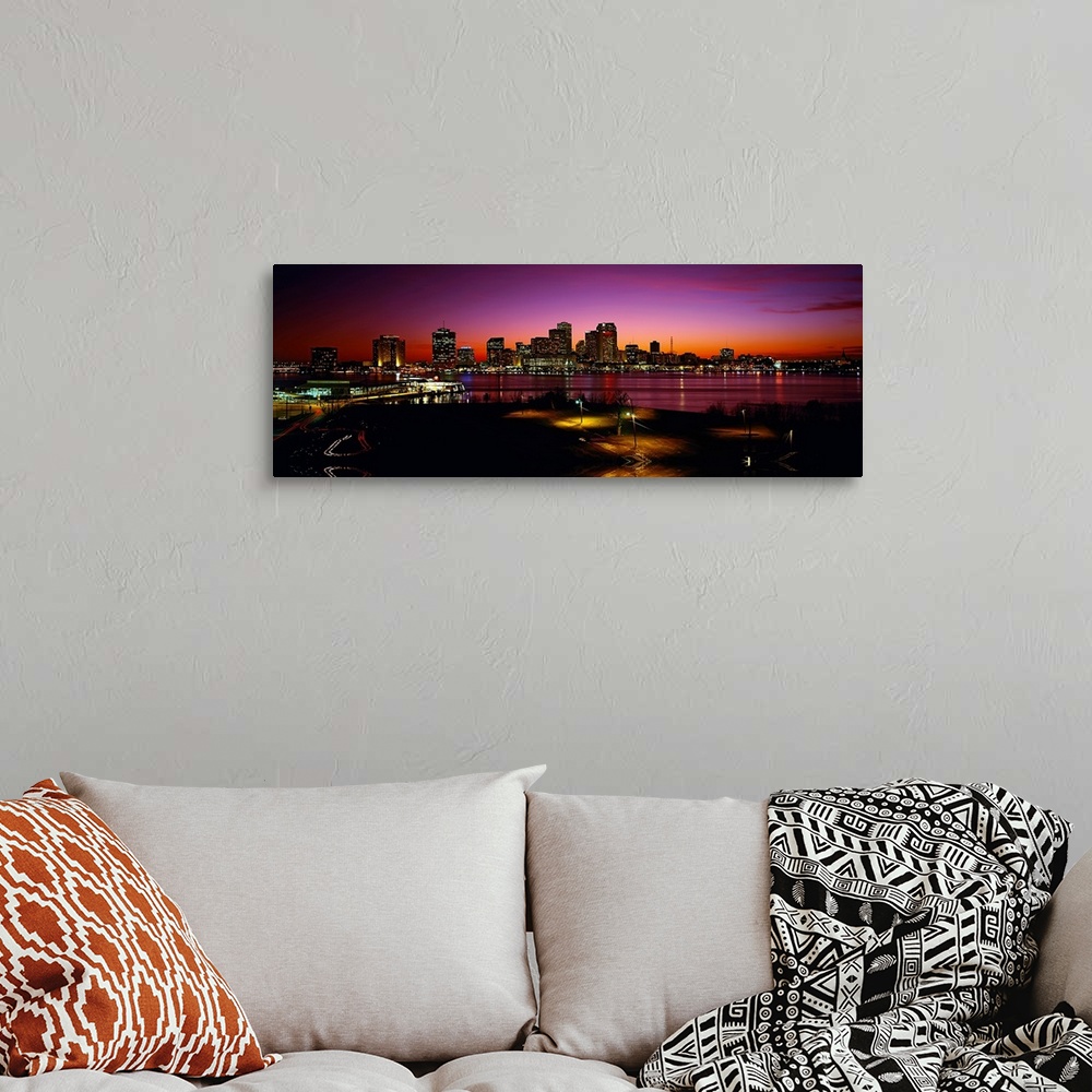 A bohemian room featuring Panoramic photograph of city skyline at sunset.  The lights from the buildings and street lamps a...