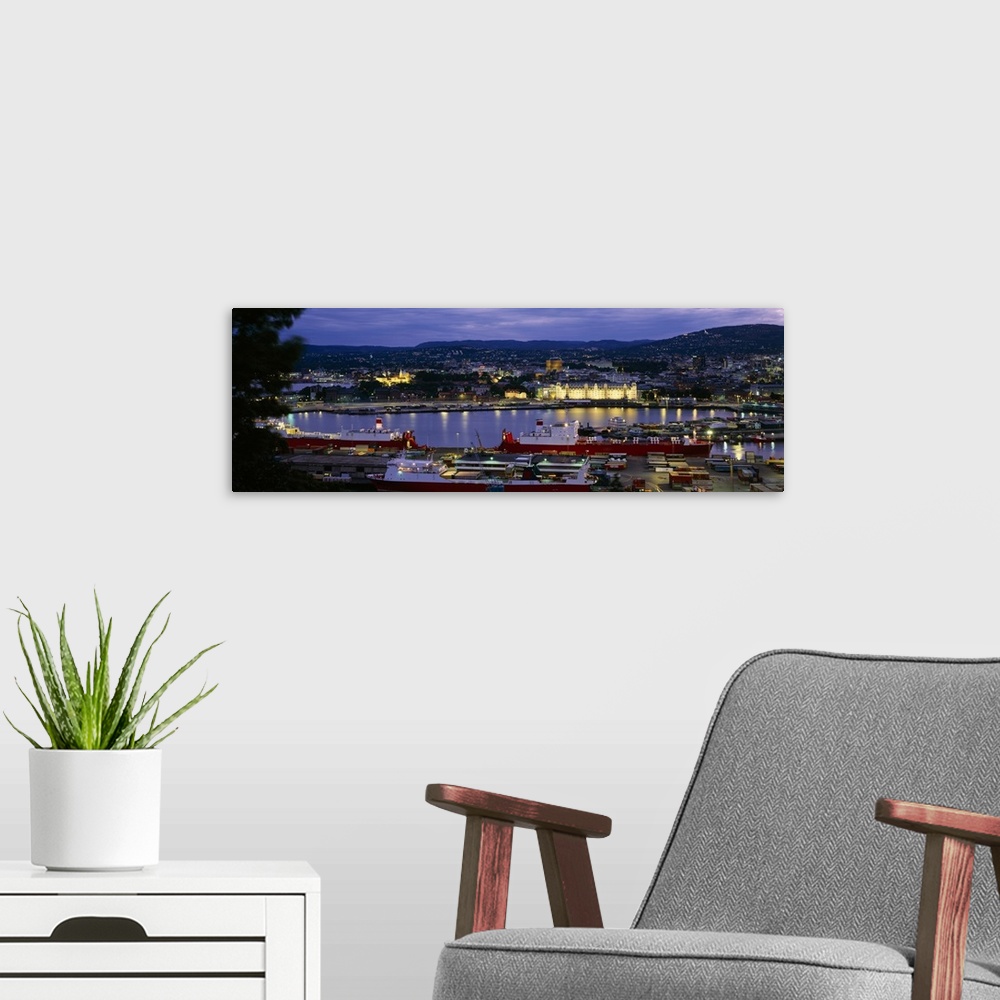 A modern room featuring Buildings lit up at night, Oslo, Norway