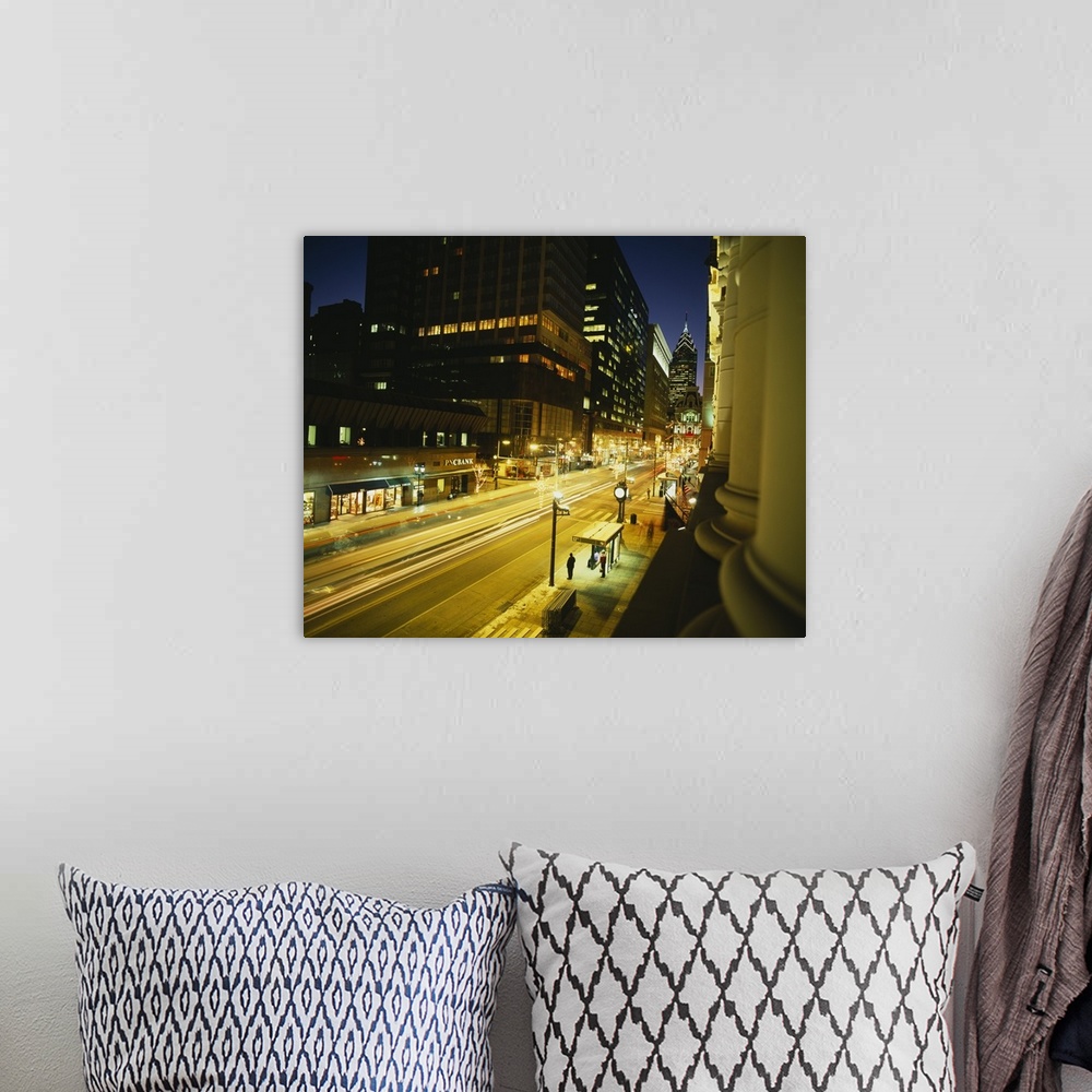 A bohemian room featuring Large photo on canvas of tall buildings and a busy street lit up in Philly.