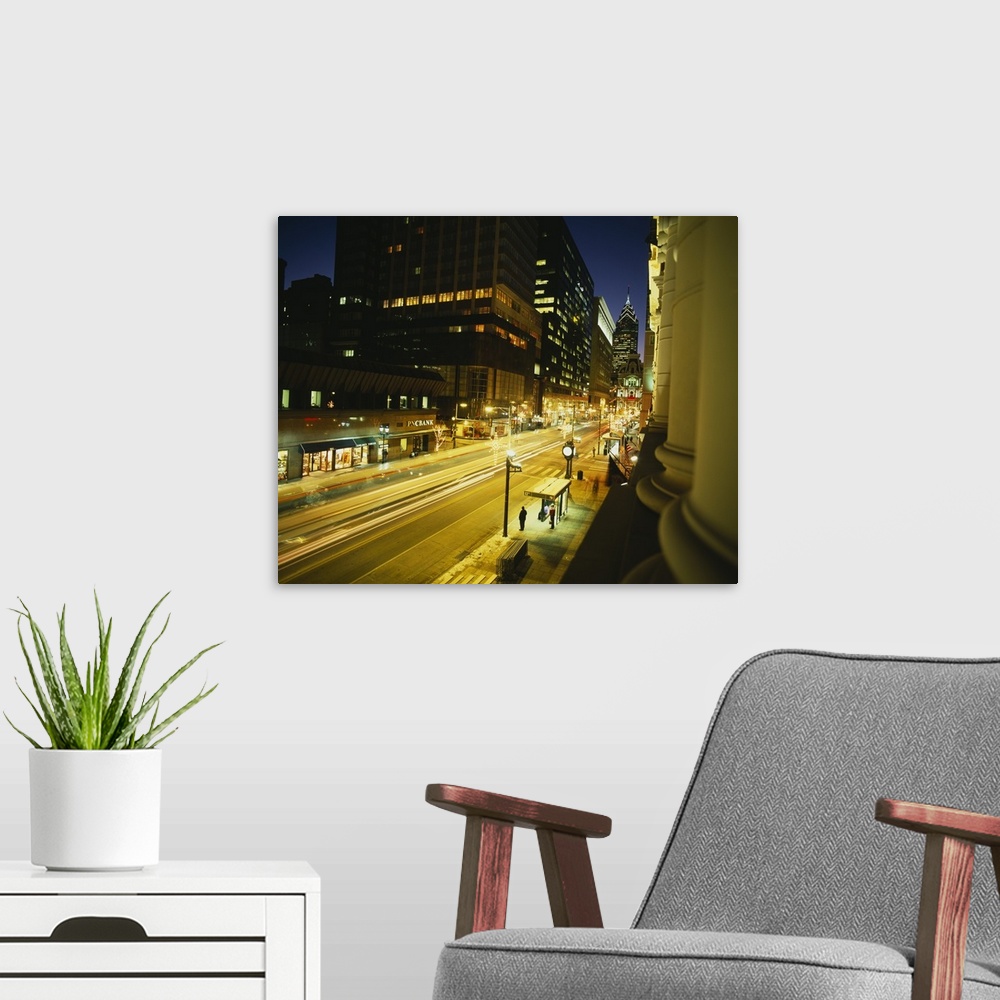 A modern room featuring Large photo on canvas of tall buildings and a busy street lit up in Philly.