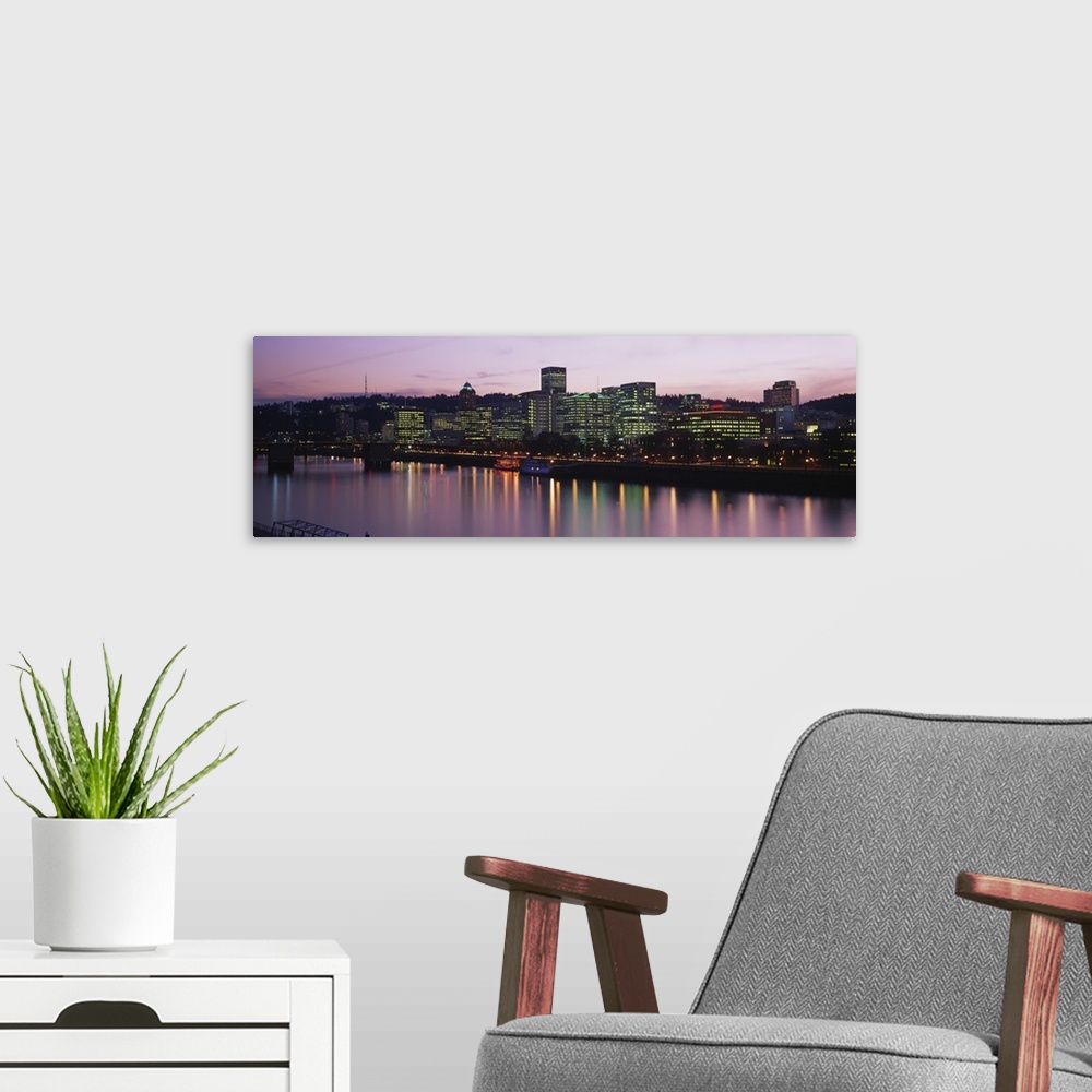 A modern room featuring This is a cityscape glowing in the evening light and reflecting in the surface of the water in th...