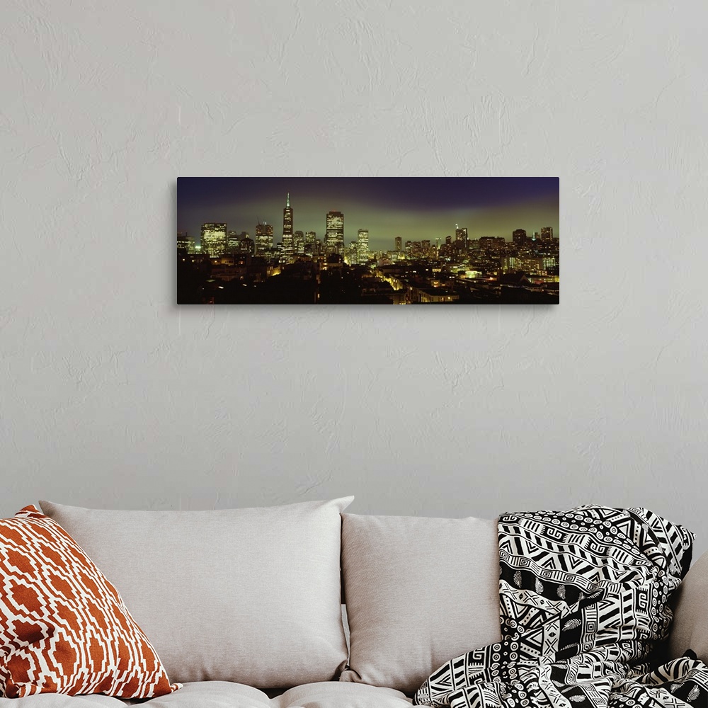 A bohemian room featuring Huge landscape panoramic photograph of downtown San Francisco with night skyline illuminated.
