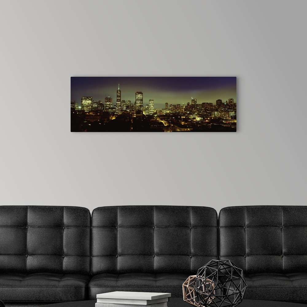 A modern room featuring Huge landscape panoramic photograph of downtown San Francisco with night skyline illuminated.