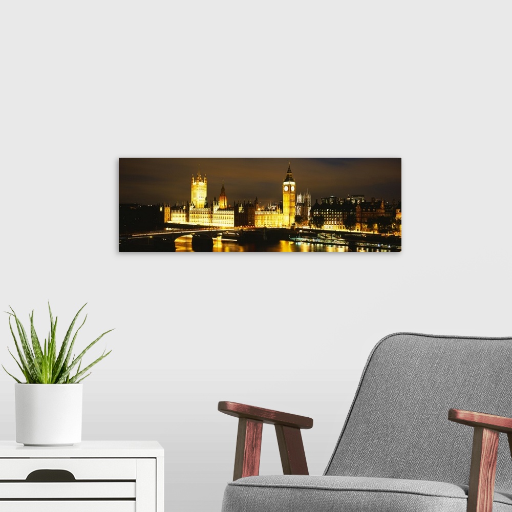 A modern room featuring This panoramic piece shows the Big Ben clock tower and the House of Parliament illuminated under ...