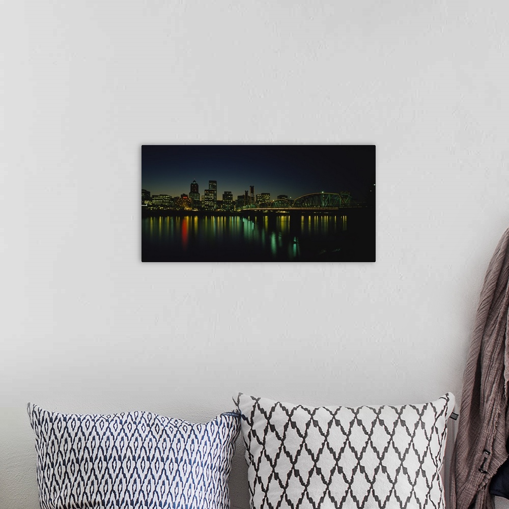 A bohemian room featuring Panoramic photograph taken of a busy city in the Northwestern United States during nighttime.  Th...