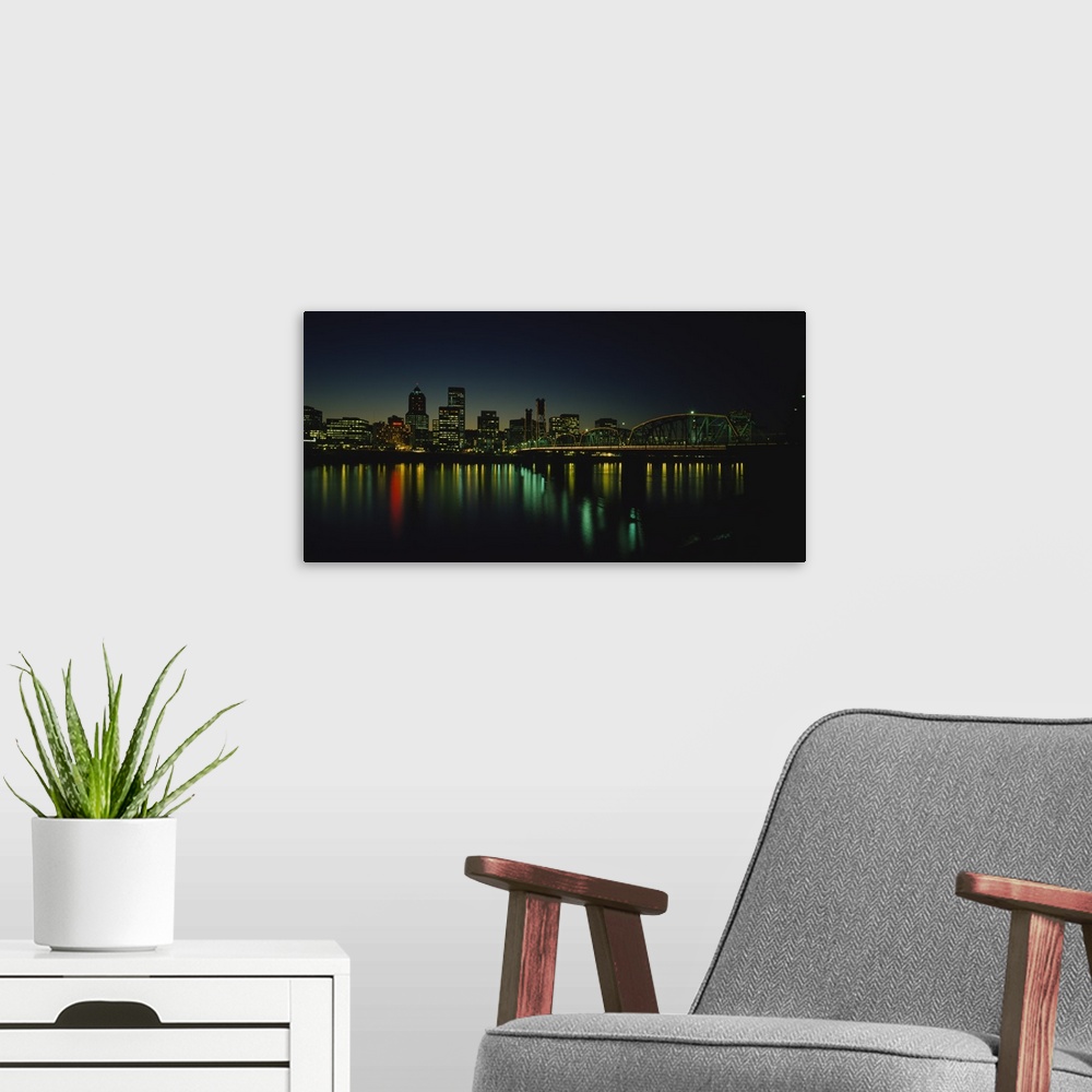 A modern room featuring Panoramic photograph taken of a busy city in the Northwestern United States during nighttime.  Th...