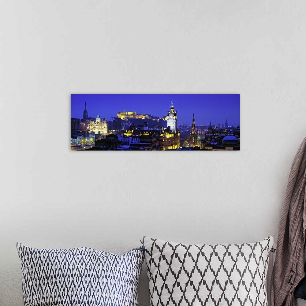 A bohemian room featuring Panoramic photograph taken of buildings in Scotland lit up at night with a castle shown in the ba...