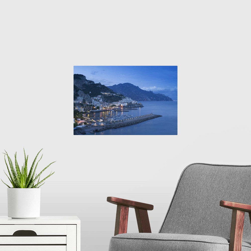 A modern room featuring Big, landscape photograph of lit buildings along a hillside on the Amalfi Coast, in Campania, Ita...