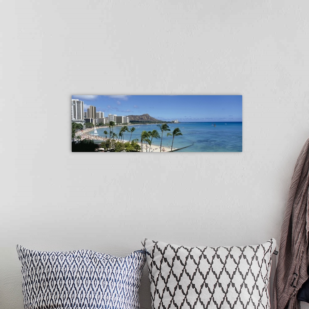 A bohemian room featuring A panoramic photograph of skyscrapers and beach goers lining the shore of this tropical beach at ...
